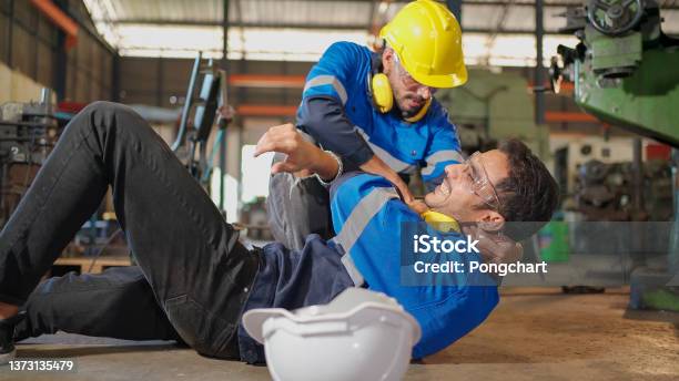 Man Labor Worker Had Accident On The Floor At The Production Line Of Cnc Machine Factory Engineer Man Walk To That Area And Support Him On Injured Safety In Industrial Factory Injury At Worknn Stock Photo - Download Image Now