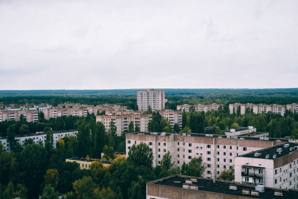 The city of Pripyat is seen from above. Clearly overgrown as it has been abandoned since 1986. The city of Pripyat, in northern Ukraine, was evacuated after the explosion at the Chernobyl Nuclear Power Plant in 1986 and despite once being home to nearly 50,000 people, has never been inhabited since. pripyat city stock pictures, royalty-free photos & images
