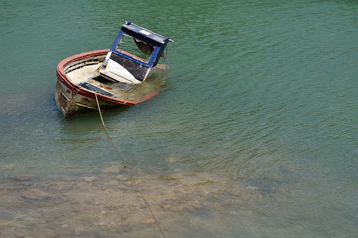 Cabo Roche, Spain. October 8th, 2011. Wrecked boat on the shore of a river