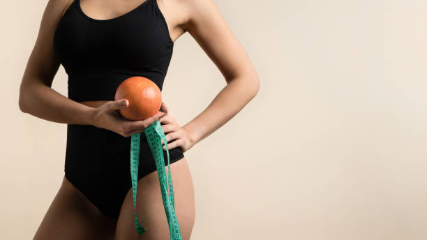 Girl with Orange and measuring tape stock photo