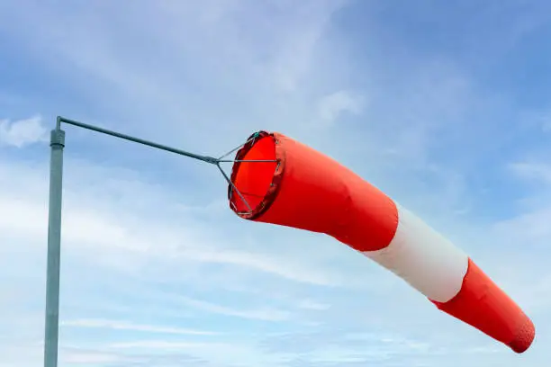 Close up of a windsock against blue sky with clouds. Reykjavik, Iceland.