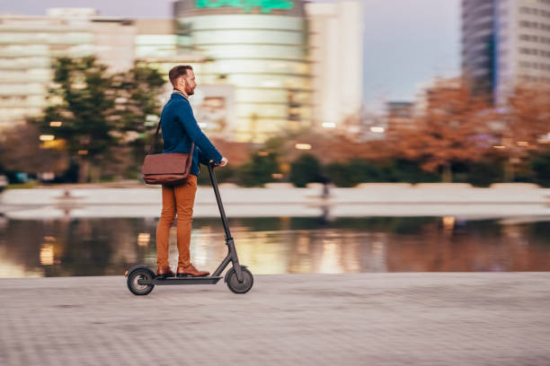 istock Businessman riding scooter at evening 1373138361