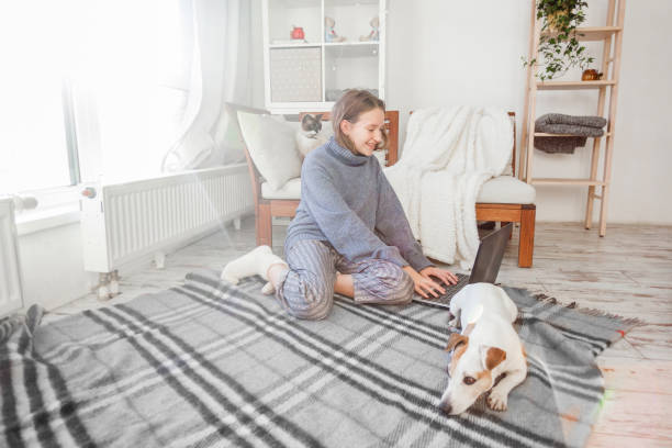 istock Relaxing young woman using laptop in living room 1373139934
