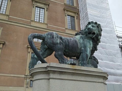 Stockholm, Sweden. August 22, 2017: Monument to a lion near the building of the Royal Palace. View.