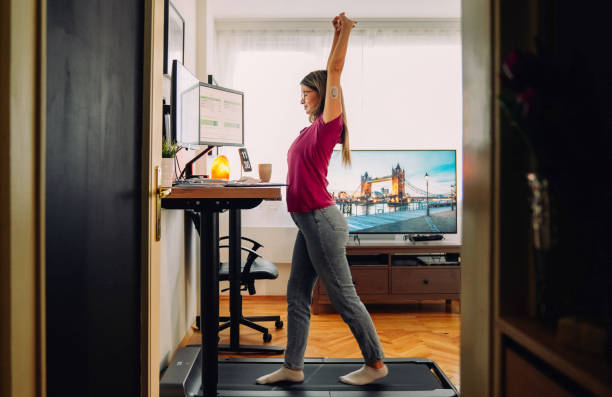 istock Woman at home office is walking on under desk treadmill 1373141335
