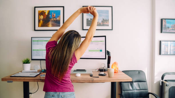 istock Young woman with diabetes working at standing desk 1373141378