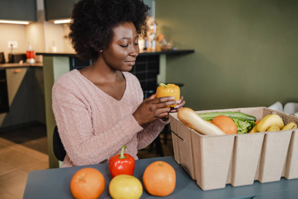 istock Unpacking fresh groceries at home 1373143378