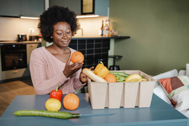 istock Unpacking fresh groceries at home 1373143452