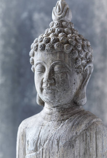istock Meditating Buddha Statue on bright background. Close up. 1373144474