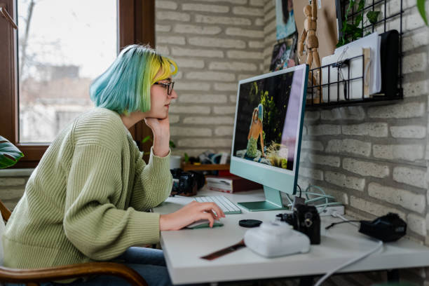istock Millennial photographer working on her photos at home office 1373147352