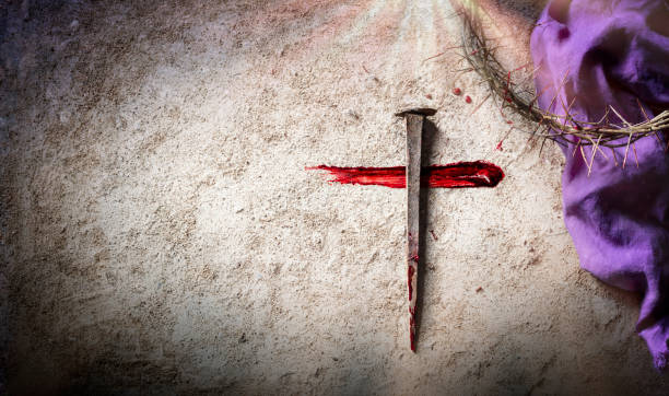 Cross And Passion - Calvary And Crucifixion Of Jesus - Crown Of Thorns And Bloody Spikes With Purple Robe On Ground stock photo