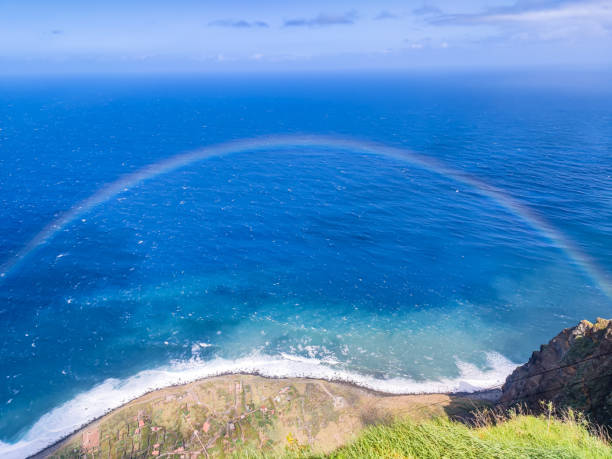 Rainbow of spectacular beauty in the Atlantic ocean as seen from the enormous height cliff in Madeira island