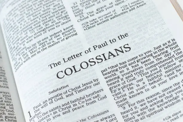 Colossians open Holy Bible Book close-up. New Testament Scripture. Studying the Word of God Jesus Christ. Christian biblical concept of faith, hope, and trust.