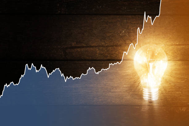 Light bulb and rising chart of electricity price stock photo