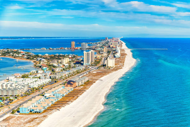 Pensacola Beach Aerial The pier along the beach at Pensacola Beach, Florida shot from an altitude of about 500 feet during a helicopter photo flight. florida beach above stock pictures, royalty-free photos & images