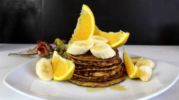 Oatmeal, banana and orange pancakes! Dipped in honey, fresh banana slices and fresh orange slices! Delicious, nutritious!!