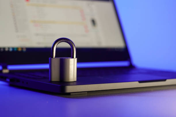 istock Locked metal padlock on a laptop keyboard over blue background. Cyber security, antivirus software concept. 1373155290