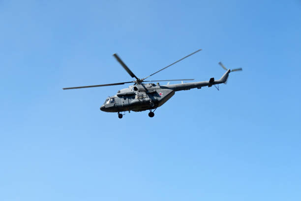 Mi-8 (NATO codification Hip), russian military helicopter in flight Mi-8 in flight on clear blue sky background hovering stock pictures, royalty-free photos & images