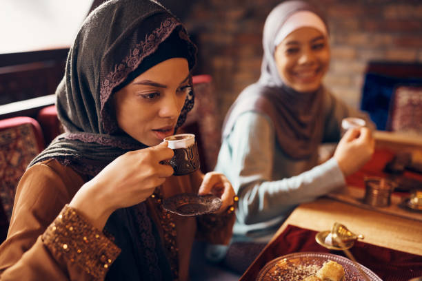 istock Young Middle Eastern woman drinking Turkish coffee during dessert at home. 1373156655