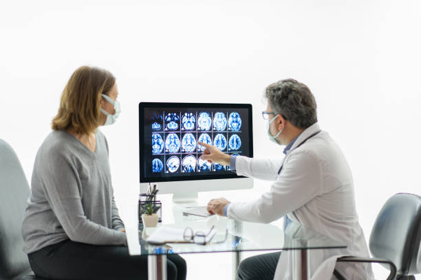 Female patient having consultation with neurologist in office stock photo