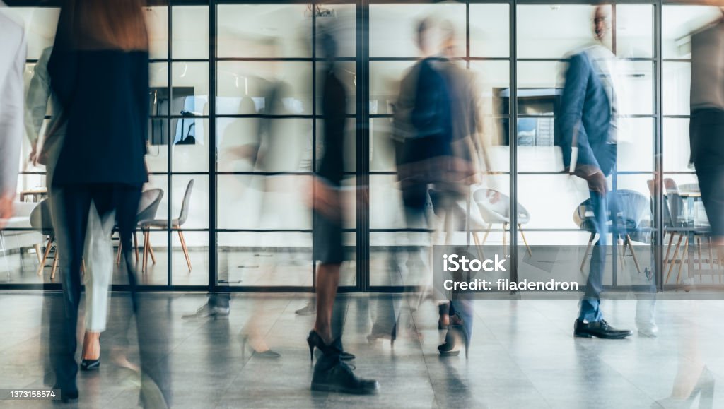 Place of work Busy modern workplace. Working process in the office, business people working, walking and talking, blurred motion Office Stock Photo