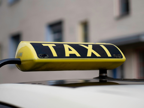 Close up of a yellow taxi sign in Berlin, Germany. No people.