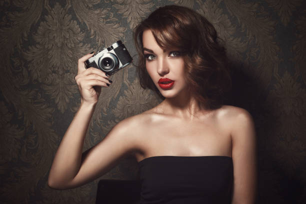 istock Beautiful woman with vintage camera 1373159245