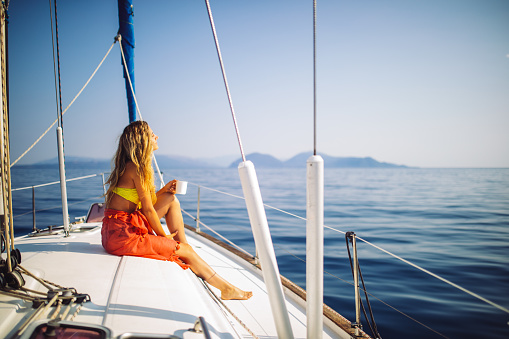 Sailing crew of 4 people on sailboat on regatta.