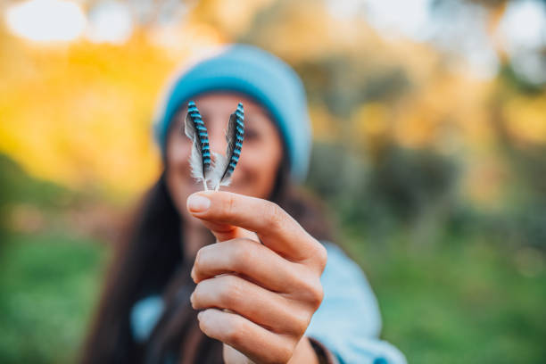 Woman Holding a Feather in Her Hand