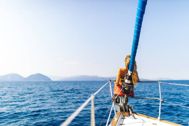 istock Young woman enjoying sailing on sailboat bow 1373159945