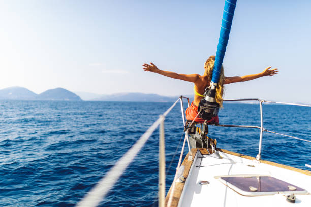 istock Young woman enjoying sailing on sailboat bow 1373159963