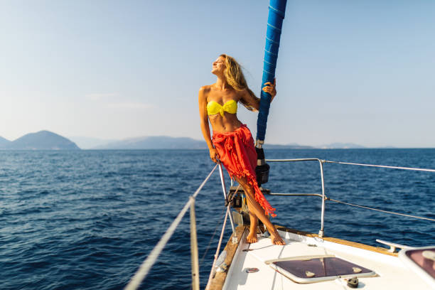 istock Young woman enjoying sailing on sailboat bow 1373159983