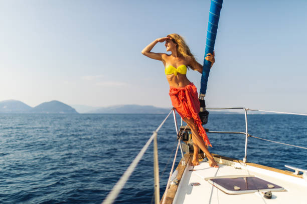 istock Young woman enjoying sailing on sailboat bow 1373159984
