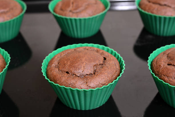fresh baked chocolate muffins on tray, close-up
