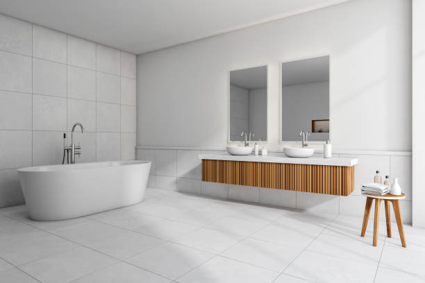 istock Bathroom interior with bathtub, sink and mirror, accessories on table 1373162763
