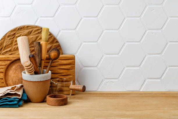 istock Kitchenware and utensils on wooden shelf or countertop with white tile wall background and copy space. Home kitchen cooking decor. Wooden equipment. 1373163780