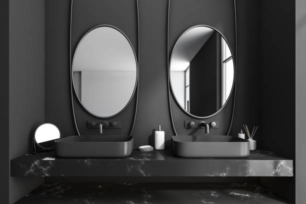 istock Bathroom interior with sink and mirror, accessories on black marble deck 1373164218