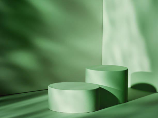 Green colour theme with two cylindrical pedestals in shaded room. 3d computer graphic template of displaying place for your products.