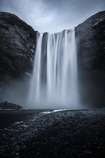 View of the majestic Skogafoss waterfall and a rainbow in Iceland