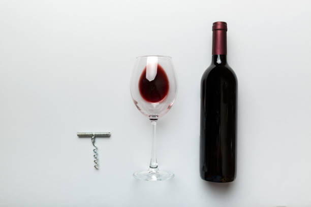 istock Flat lay composition with corkscrew, bottle of wine and elegant glass on colored table. Flat lay, top view wth copy space 1373171090