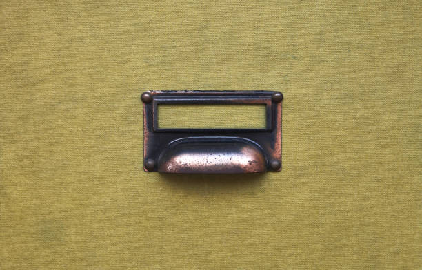 detail of a metal handle on a fabric texture of a filing cabinet
