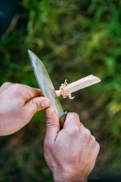 istock Man Preparing Wood for Camp Fire 1373172720