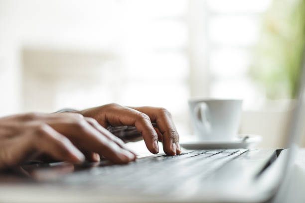 istock closeup view of dark skinned hands typing in keyboard, work concept 1373173438