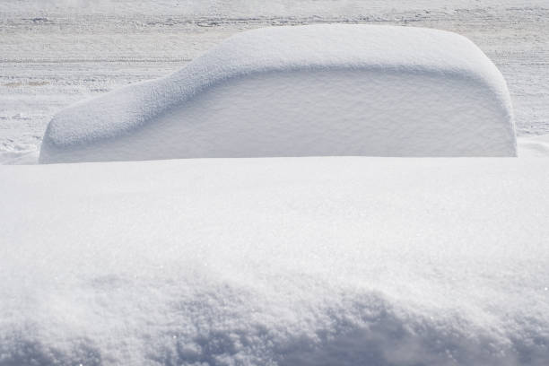 a car covered in snow in the mountains in the Alps
