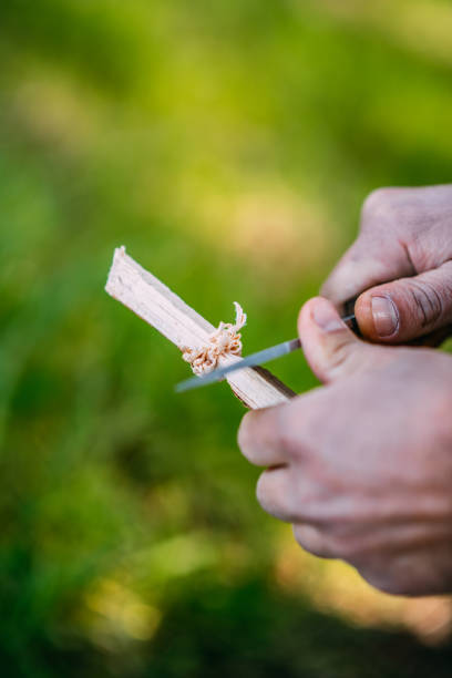 istock Man Preparing Wood for Camp Fire 1373174767