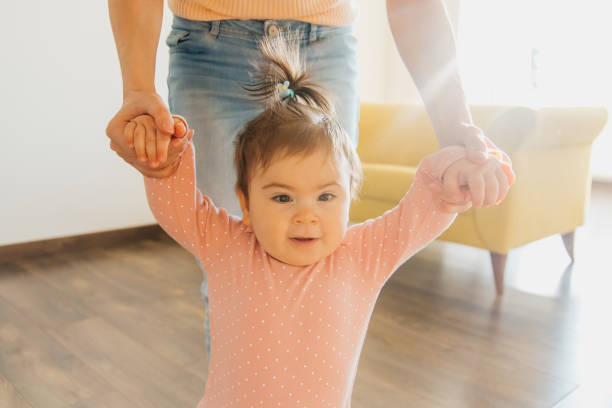 istock close up view of happy baby's face learning to walk toddler taking first steps 1373176727