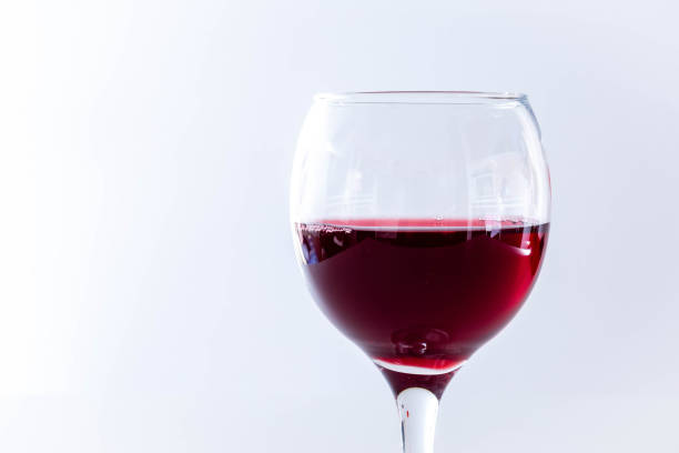 istock One crystal goblet filled with red wine. Wine glass isolated on white background 1373179417