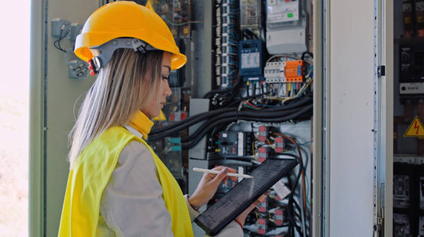 istock Female engineer working in solar power plant. Renewable energy systems. Solar city. 1373189908