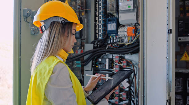 Female engineer working in solar power plant. Renewable energy systems. Solar city. stock photo