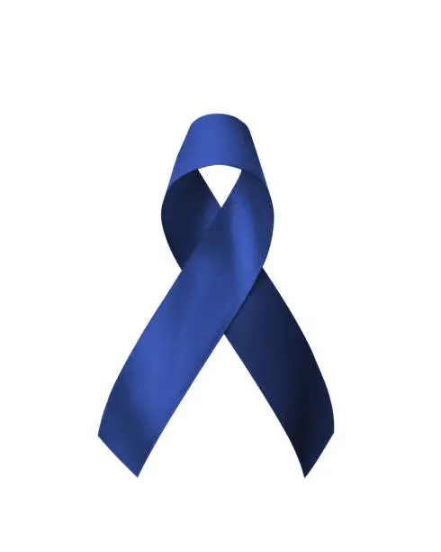 Photo of Dark blue ribbon for colon cancer and colorectal cancer awareness, Acute Respiratory Distress Syndrome (ARDS), Juvenile Arthritis, Tuberous Sclerosis, bow isolated on white background (clipping path)